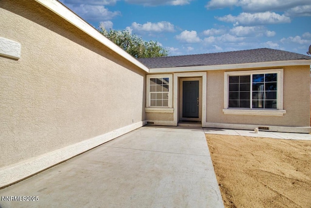 1563 Maria Ct, Fernley, NV 89408 - view of exterior entry featuring a patio and stucco siding