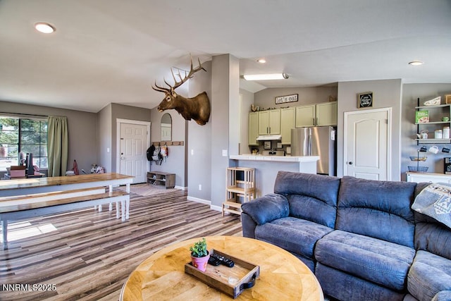 1563 Maria Ct, Fernley, NV 89408 - living area with vaulted ceiling, baseboards, wood finished floors, and recessed lighting