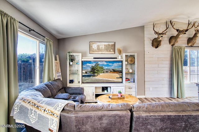 1563 Maria Ct, Fernley, NV 89408 - living room featuring lofted ceiling, wood finished floors, and wood walls