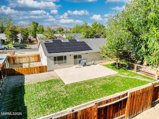1563 Maria Ct, Fernley, NV 89408 - back of house featuring roof mounted solar panels, stucco siding, a patio, and a shingled roof