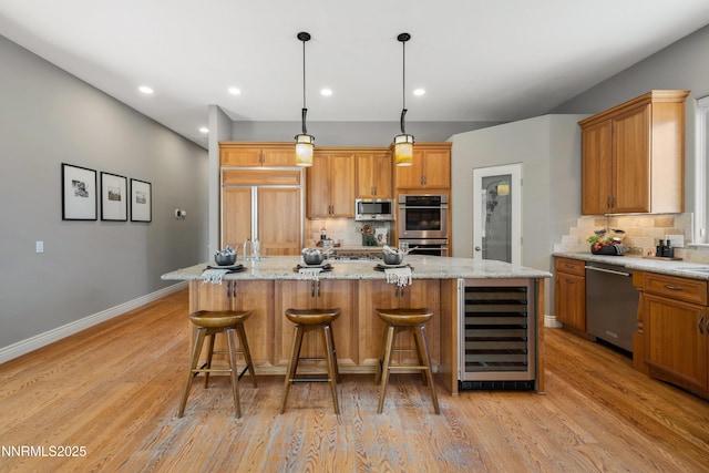 193 N Argyle Ct, Reno, NV 89511 - kitchen with wine cooler, appliances with stainless steel finishes, tasteful backsplash, light wood finished floors, and recessed lighting
