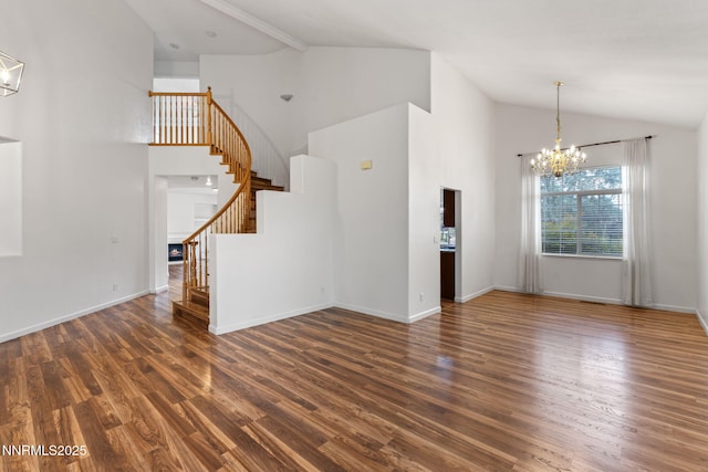 3095 Fairwood Dr, Reno, NV 89502 - unfurnished living room featuring stairs, wood finished floors, a chandelier, high vaulted ceiling, and baseboards