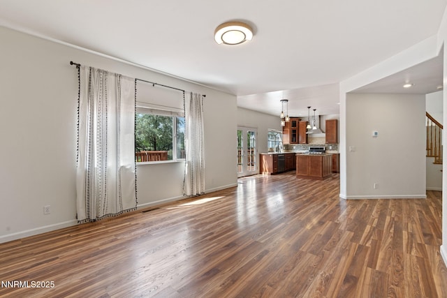 3095 Fairwood Dr, Reno, NV 89502 - unfurnished living room featuring stairway, dark wood-style floors, and baseboards