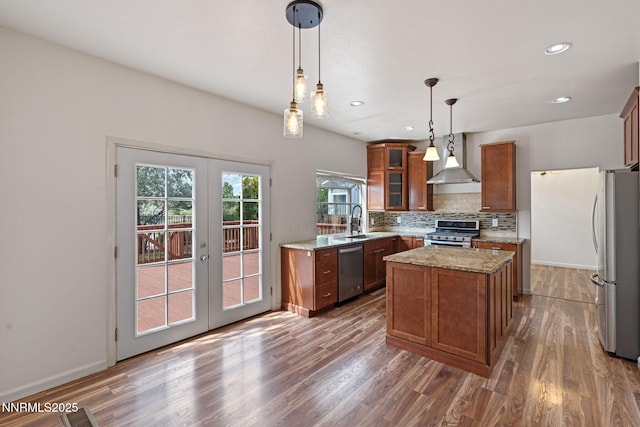 3095 Fairwood Dr, Reno, NV 89502 - kitchen with appliances with stainless steel finishes, wall chimney range hood, french doors, brown cabinetry, and dark wood-type flooring