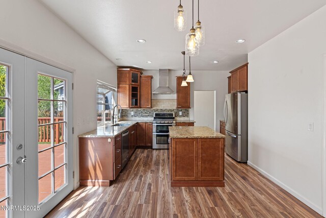 3095 Fairwood Dr, Reno, NV 89502 - kitchen with appliances with stainless steel finishes, wall chimney exhaust hood, dark wood-style flooring, light stone countertops, and recessed lighting