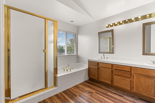 3095 Fairwood Dr, Reno, NV 89502 - full bath with lofted ceiling, a bath, wood finished floors, a shower stall, and double vanity