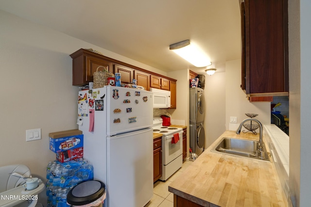 4930 Catalina Dr Apt 3, Reno, NV 89502 - kitchen featuring white appliances, a sink, stacked washer / dryer, light tile patterned floors, and wooden counters