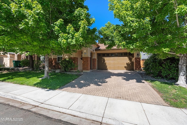 11285 Messina Way, Reno, NV 89521 - obstructed view of property with decorative driveway, a garage, brick siding, and a front lawn