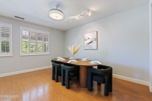11285 Messina Way, Reno, NV 89521 - dining room with baseboards, rail lighting, and light wood-type flooring