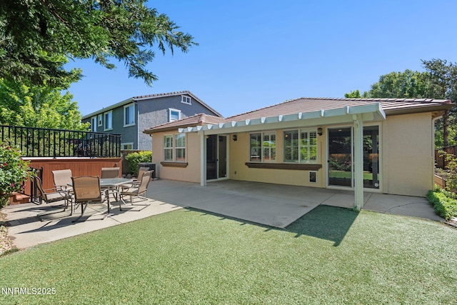 11285 Messina Way, Reno, NV 89521 - back of house with stucco siding, a patio area, a tiled roof, and a lawn