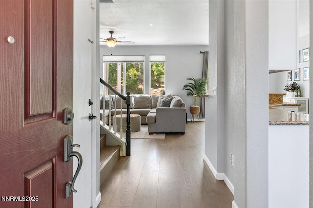 2349 Dodge Dr, Sparks, NV 89436 - entryway featuring light wood-style floors, ceiling fan, stairs, and baseboards