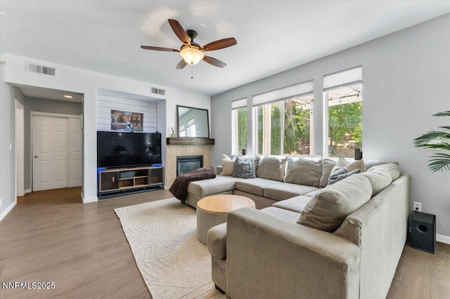 2349 Dodge Dr, Sparks, NV 89436 - living room featuring a ceiling fan, wood finished floors, baseboards, and a glass covered fireplace