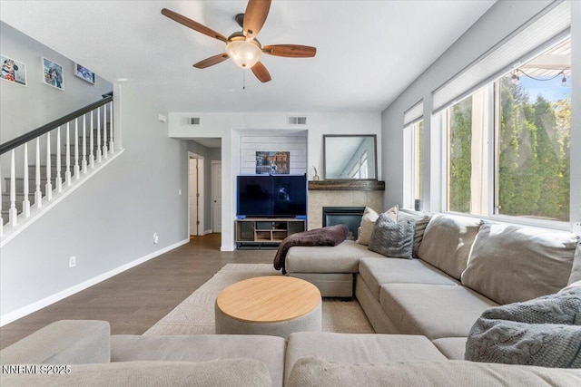 2349 Dodge Dr, Sparks, NV 89436 - living area featuring wood finished floors, ceiling fan, stairs, a fireplace, and baseboards