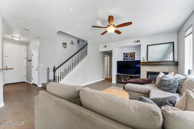 2349 Dodge Dr, Sparks, NV 89436 - living area with stairway, a ceiling fan, dark wood-style floors, baseboards, and a tile fireplace