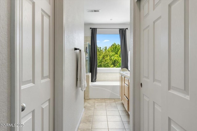 2349 Dodge Dr, Sparks, NV 89436 - full bathroom featuring a textured wall, tile patterned floors, a garden tub, and baseboards