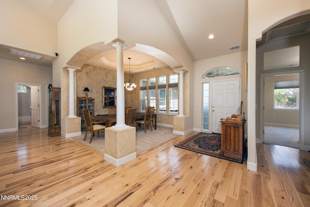 1601 Jones St, Minden, NV 89423 - entryway featuring hardwood / wood-style flooring, high vaulted ceiling, a chandelier, ornate columns, and baseboards