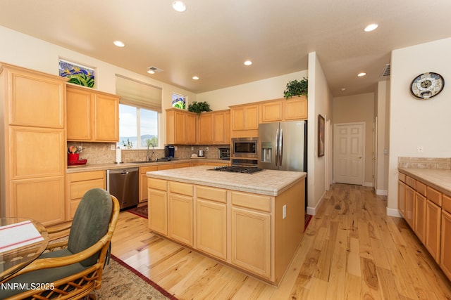 1601 Jones St, Minden, NV 89423 - kitchen with stainless steel appliances, light brown cabinetry, backsplash, and recessed lighting