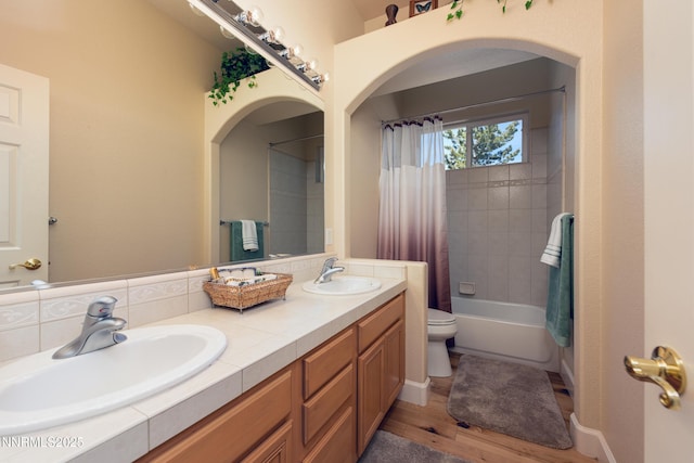 1601 Jones St, Minden, NV 89423 - bathroom featuring double vanity, toilet, wood finished floors, and shower / bath combo