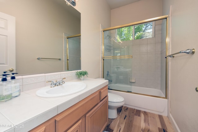 1601 Jones St, Minden, NV 89423 - full bathroom featuring vanity, wood finished floors, toilet, and enclosed tub / shower combo