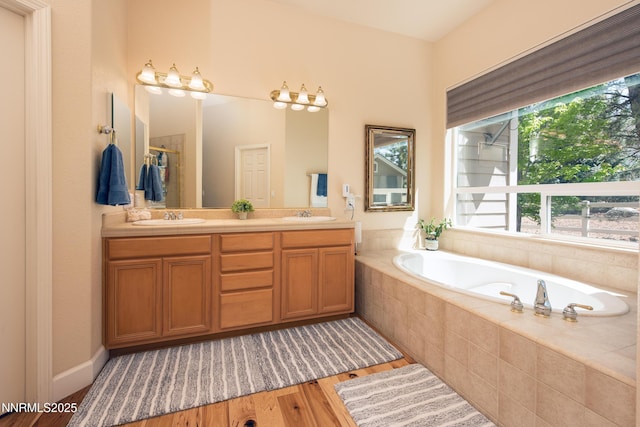 1601 Jones St, Minden, NV 89423 - bathroom featuring wood finished floors, a garden tub, and double vanity