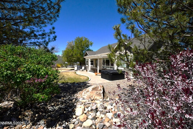1601 Jones St, Minden, NV 89423 - view of yard featuring a hot tub and a patio area