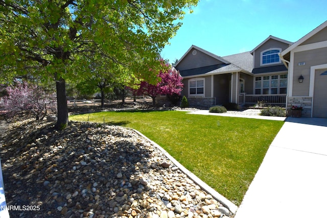 1601 Jones St, Minden, NV 89423 - craftsman-style house with stone siding, a front lawn, concrete driveway, and an attached garage