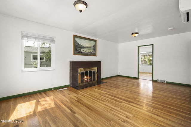 438 Glenmanor Dr, Reno, NV 89509 - unfurnished living room featuring wood finished floors, baseboards, and a fireplace with flush hearth
