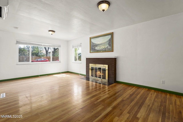 438 Glenmanor Dr, Reno, NV 89509 - unfurnished living room with baseboards, wood finished floors, and a brick fireplace