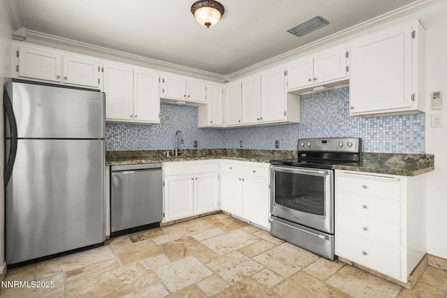438 Glenmanor Dr, Reno, NV 89509 - kitchen featuring appliances with stainless steel finishes, stone tile flooring, a sink, dark stone counters, and ornamental molding