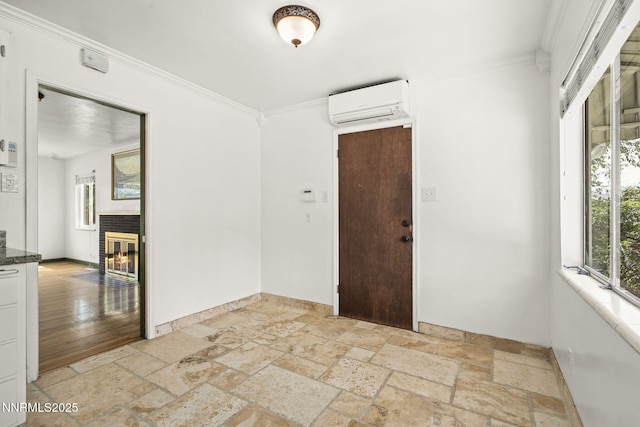 438 Glenmanor Dr, Reno, NV 89509 - foyer entrance featuring a wall unit AC, crown molding, stone tile flooring, a brick fireplace, and baseboards