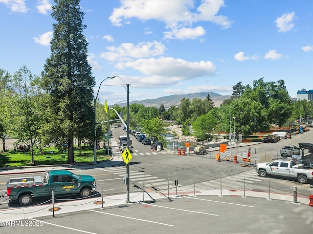 280 Island Ave Unit 302, Reno, NV 89501 - view of asphalt road featuring a mountain view, street lighting, traffic signs, curbs, and sidewalks