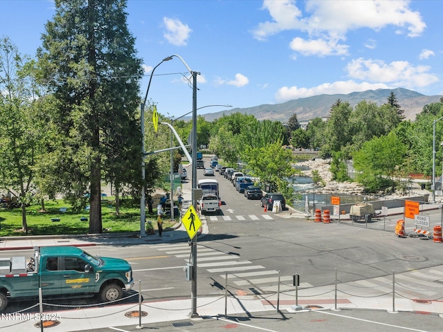 280 Island Ave Unit 302, Reno, NV 89501 - view of asphalt street with traffic signs, a mountain view, curbs, street lights, and sidewalks