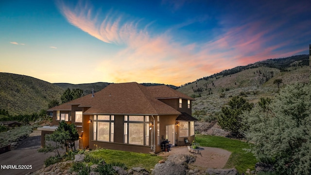 6 Canyon Dr, Carson City, NV 89703 - back of house featuring stucco siding, a mountain view, a shingled roof, and a patio area