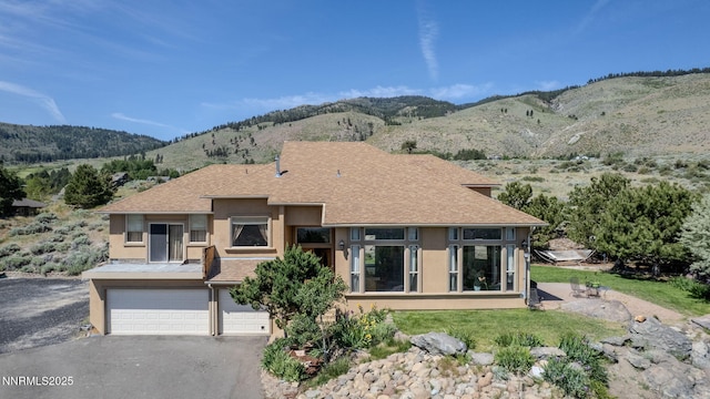 6 Canyon Dr, Carson City, NV 89703 - view of front of property featuring stucco siding, a garage, a mountain view, a shingled roof, and asphalt driveway