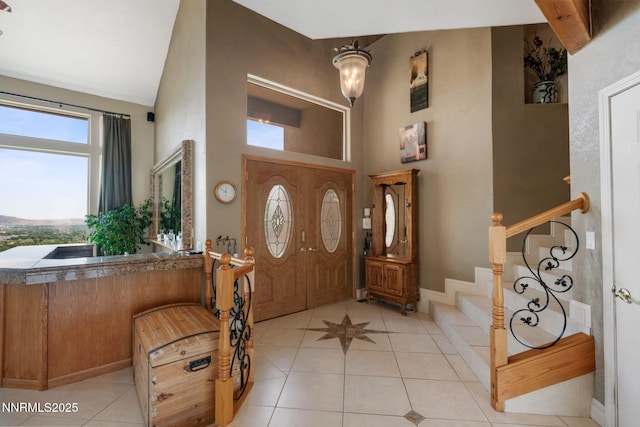 6 Canyon Dr, Carson City, NV 89703 - entryway featuring a high ceiling, light tile patterned flooring, stairs, and baseboards