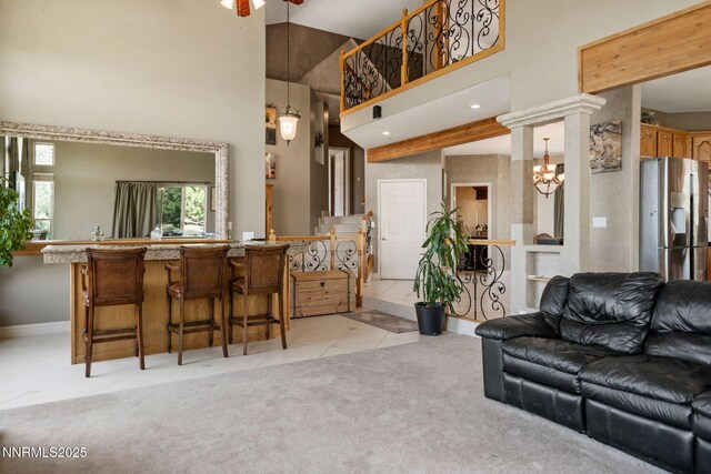 6 Canyon Dr, Carson City, NV 89703 - living room featuring a towering ceiling, light tile patterned flooring, a ceiling fan, baseboards, and a chandelier