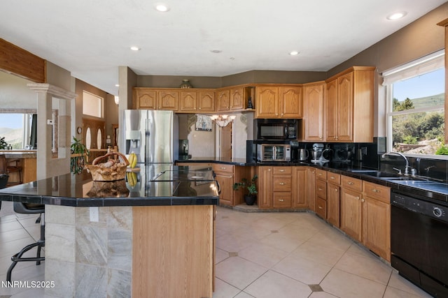 6 Canyon Dr, Carson City, NV 89703 - kitchen with black appliances, a sink, tasteful backsplash, a breakfast bar area, and light tile patterned flooring