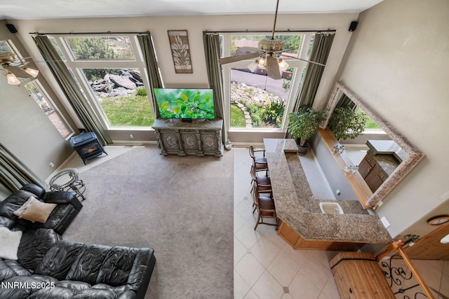 6 Canyon Dr, Carson City, NV 89703 - tiled living room with a ceiling fan, healthy amount of natural light, and a wood stove