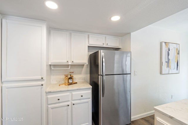 1821 Fargo Way, Sparks, NV 89434 - kitchen with freestanding refrigerator, white cabinets, baseboards, light stone countertops, and dark wood-style floors