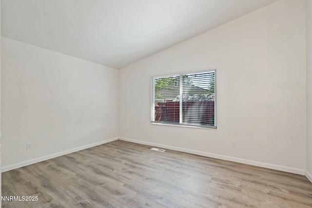 1821 Fargo Way, Sparks, NV 89434 - spare room featuring vaulted ceiling, wood finished floors, and baseboards