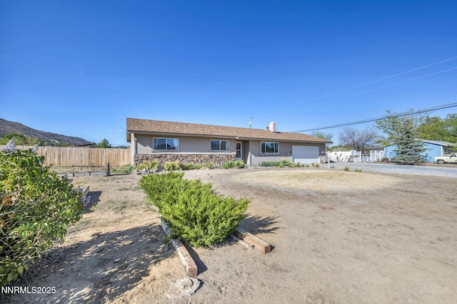 11815 Mistletoe St, Reno, NV 89506 - single story home featuring a garage, stone siding, stucco siding, and dirt driveway
