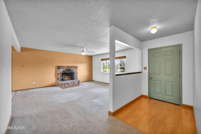 11815 Mistletoe St, Reno, NV 89506 - carpeted foyer featuring ceiling fan, a textured ceiling, a fireplace, and baseboards