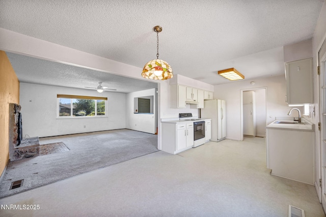 11815 Mistletoe St, Reno, NV 89506 - kitchen featuring range with electric stovetop, freestanding refrigerator, a sink, open floor plan, and a textured ceiling