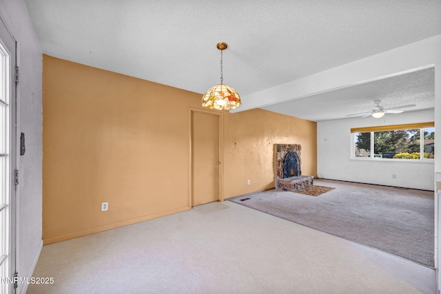 11815 Mistletoe St, Reno, NV 89506 - unfurnished living room featuring a textured ceiling, a ceiling fan, carpet flooring, and a fireplace