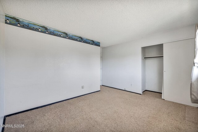 11815 Mistletoe St, Reno, NV 89506 - unfurnished bedroom with light carpet, a textured ceiling, and a closet
