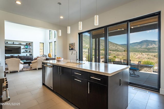 310 James Canyon Loop, Genoa, NV 89411 - kitchen featuring a sink, stainless steel dishwasher, a center island with sink, light tile patterned flooring, and dark cabinets