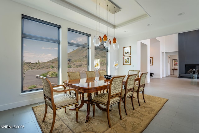 310 James Canyon Loop, Genoa, NV 89411 - dining space with a tray ceiling, baseboards, and light tile patterned flooring