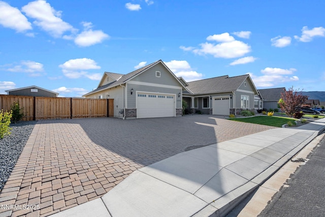 11621 Desert Shadow Dr, Sparks, NV 89441 - single story home with an attached garage, decorative driveway, and stone siding