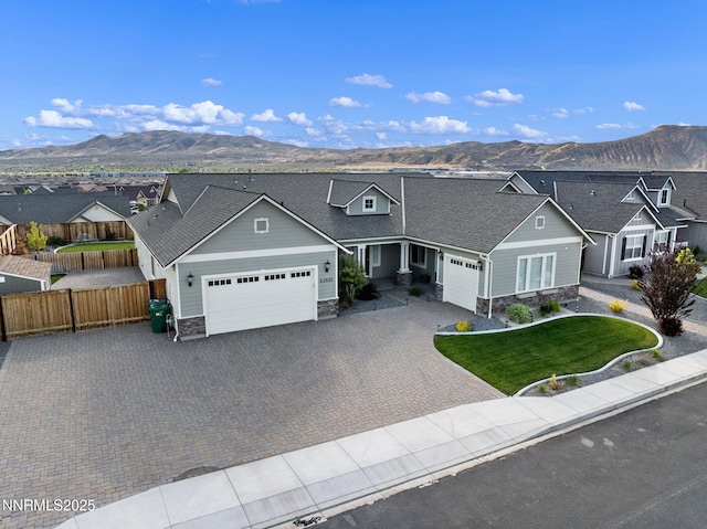 11621 Desert Shadow Dr, Sparks, NV 89441 - view of front facade with a garage, stone siding, and a mountain view