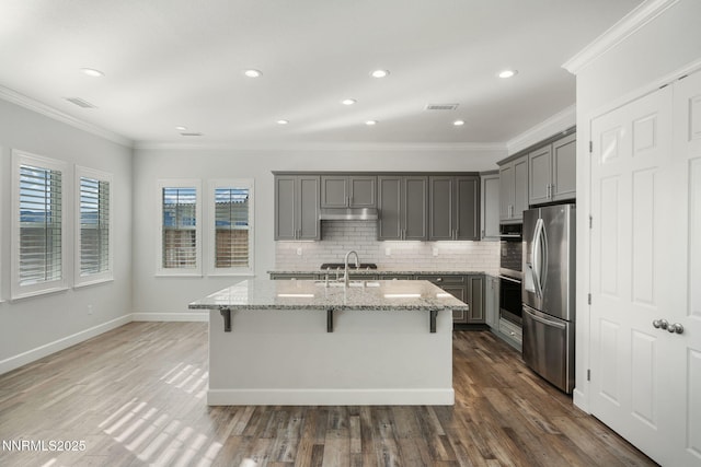 11621 Desert Shadow Dr, Sparks, NV 89441 - kitchen featuring appliances with stainless steel finishes, gray cabinets, ornamental molding, light stone counters, and tasteful backsplash